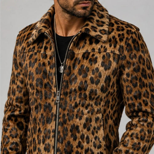 A man wearing a brown and black leopard print zip-up jacket with a fuzzy collar, shown from the chest down against a plain gray background.